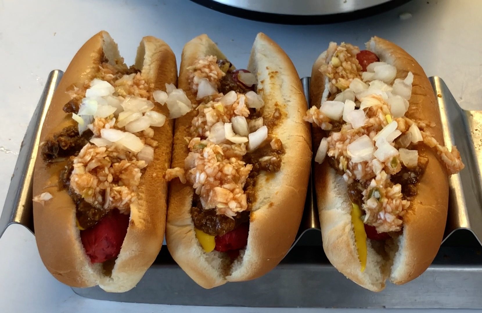 hamburgers and hot dogs sold at a nascar race crossword